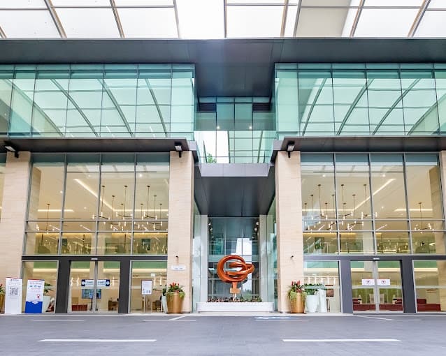 Glass entrance and sculpture at Bangkok International Hospital